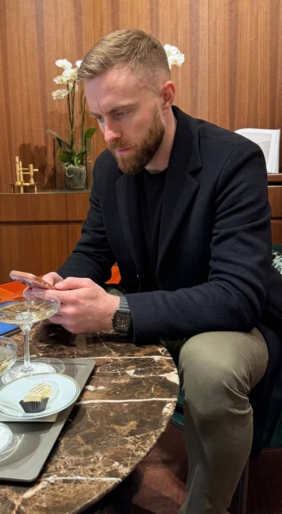 Ethan working on the phone at a marble table
